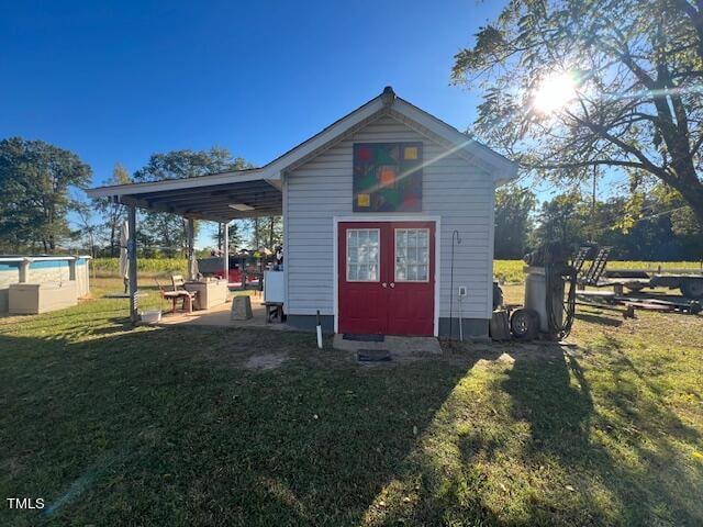 view of outbuilding featuring a lawn