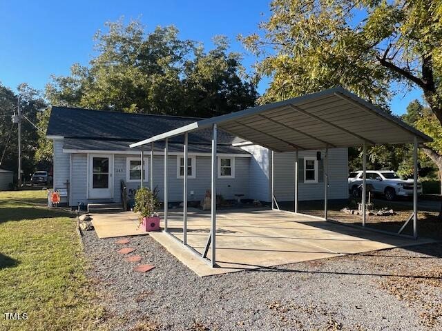 exterior space featuring a lawn and a carport