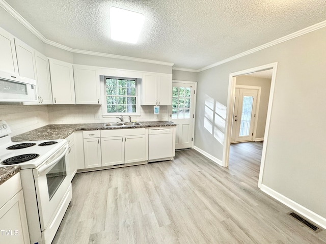 kitchen with light wood-type flooring, white appliances, and white cabinetry