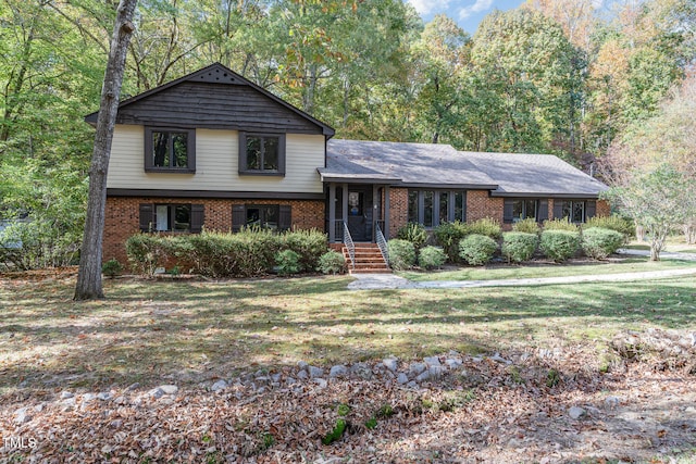 tri-level home with a front yard