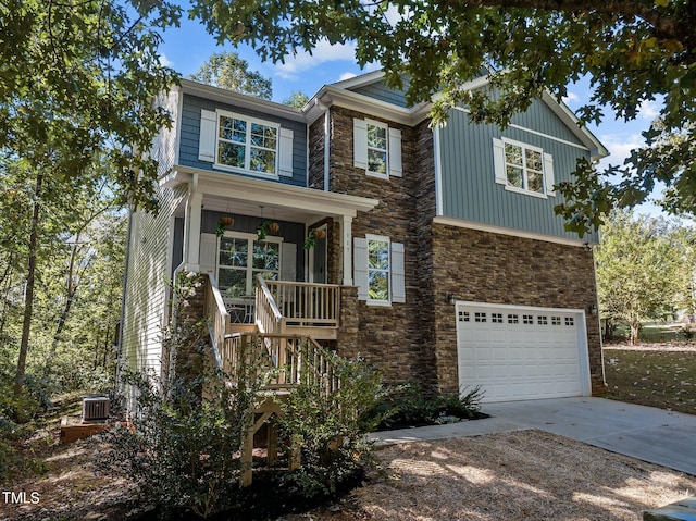 craftsman house featuring central air condition unit, covered porch, and a garage