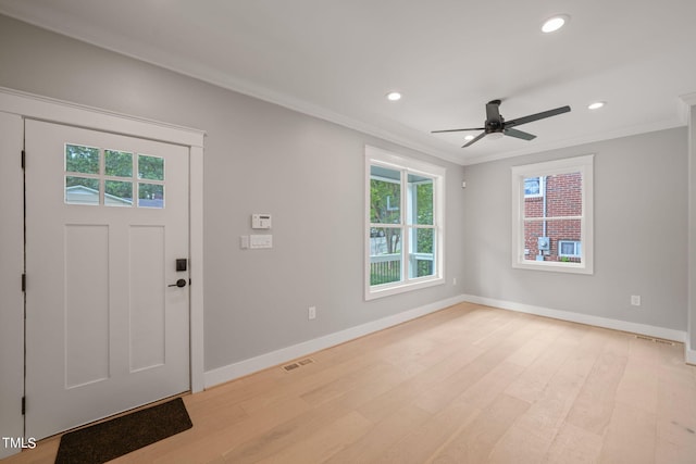 entryway featuring ceiling fan, light wood-type flooring, and ornamental molding