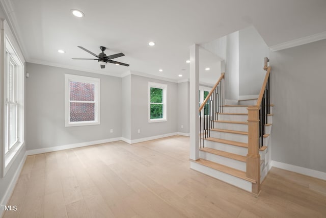 stairs with hardwood / wood-style floors, ceiling fan, and crown molding