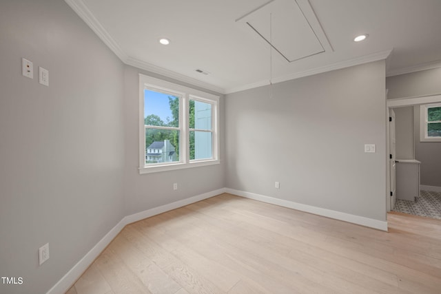 unfurnished room featuring light hardwood / wood-style floors and crown molding