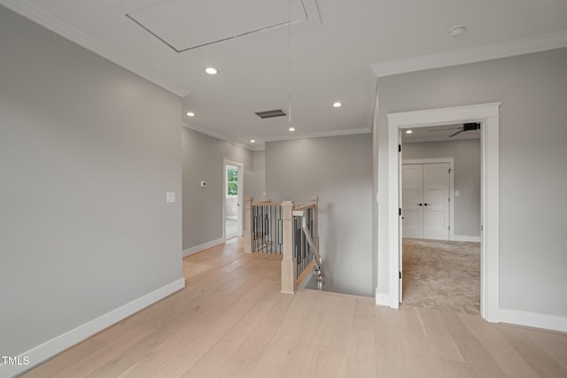 corridor with crown molding and light hardwood / wood-style flooring