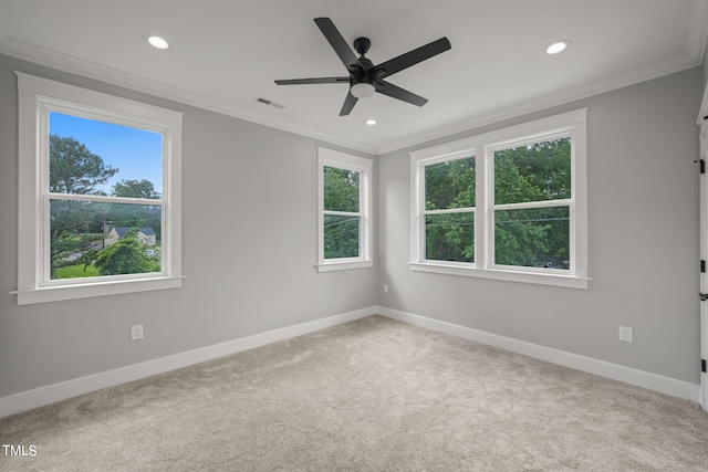 empty room with crown molding, ceiling fan, and light carpet