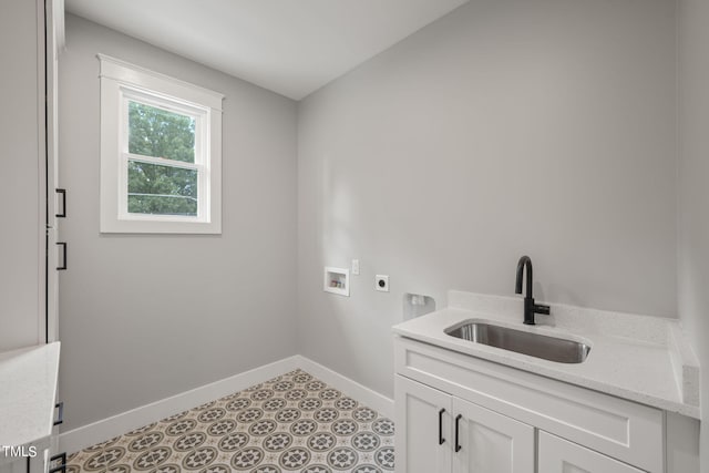 clothes washing area with hookup for an electric dryer, cabinets, sink, and hookup for a washing machine