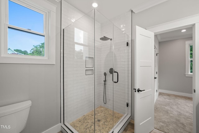 bathroom with crown molding, an enclosed shower, and toilet