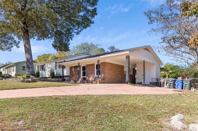 ranch-style house featuring a front yard and a carport