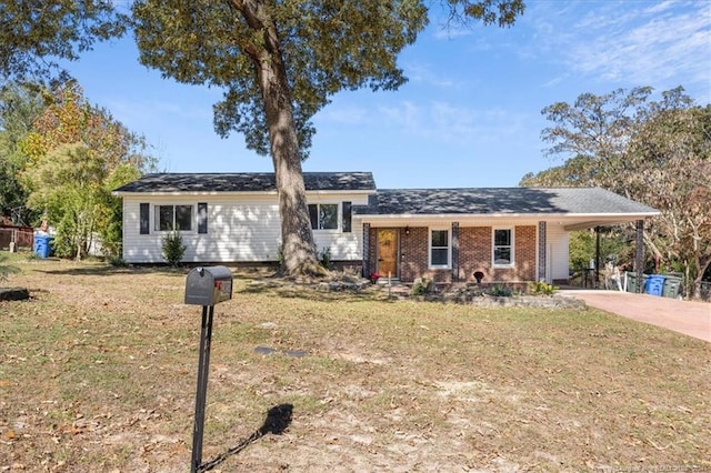 ranch-style home featuring a carport and a front yard