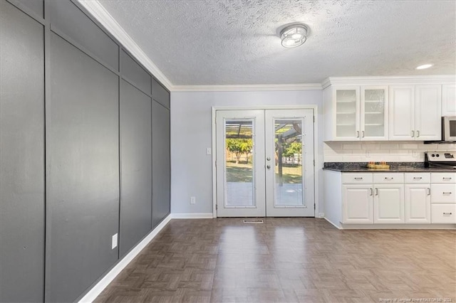 kitchen featuring ornamental molding, french doors, white cabinetry, and parquet floors