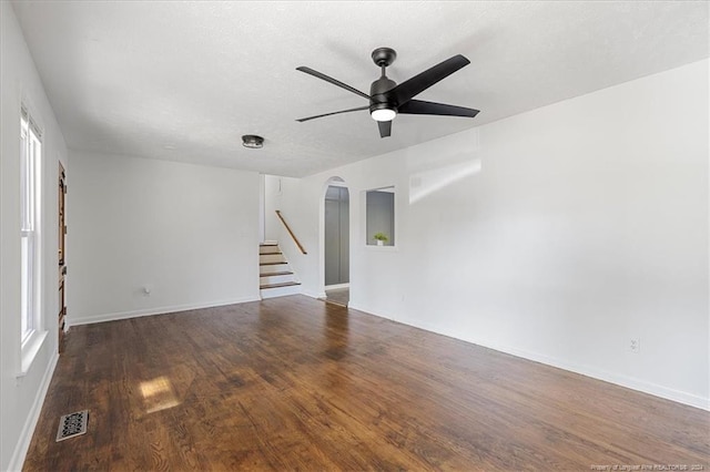 unfurnished room with dark wood-type flooring, ceiling fan, and a textured ceiling