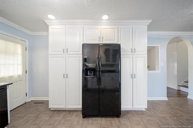 kitchen with crown molding, white cabinets, light parquet floors, and black fridge with ice dispenser