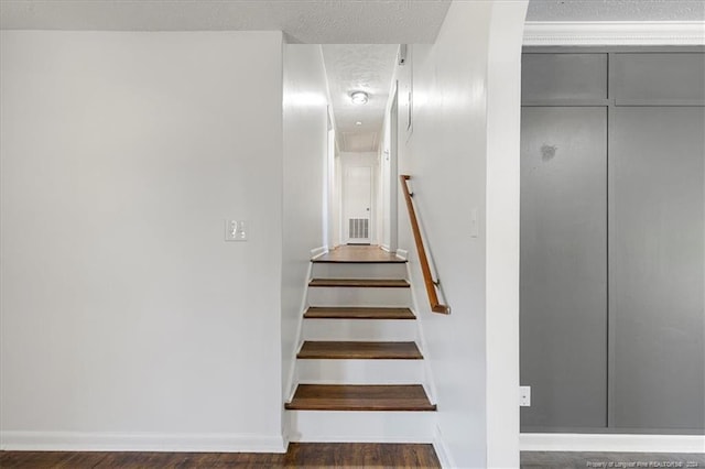 staircase featuring wood-type flooring