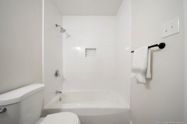 bathroom featuring toilet and tiled shower / bath combo