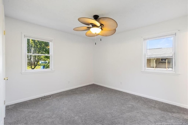 unfurnished room with carpet, ceiling fan, and plenty of natural light
