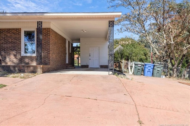 doorway to property featuring a carport