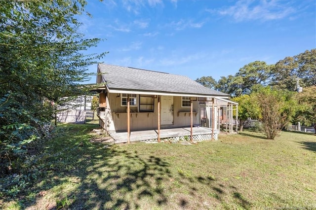 rear view of house featuring a lawn
