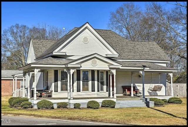 view of front facade with a front yard and covered porch