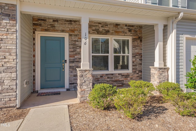 view of exterior entry featuring a porch