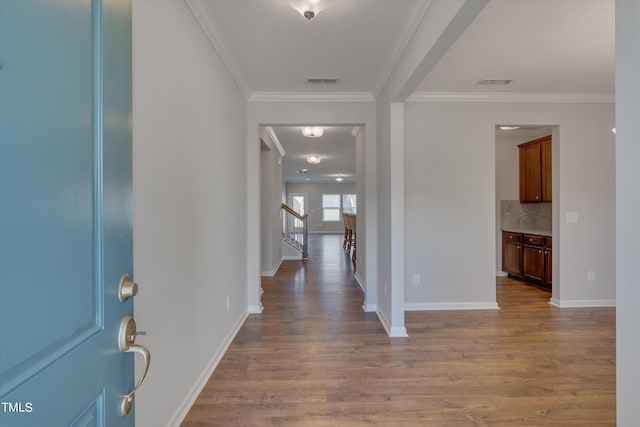 entrance foyer with crown molding and hardwood / wood-style flooring