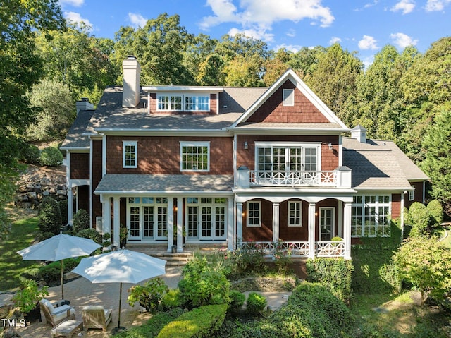 rear view of property with a patio area and a balcony