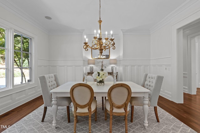 dining space featuring crown molding, a notable chandelier, and wood-type flooring