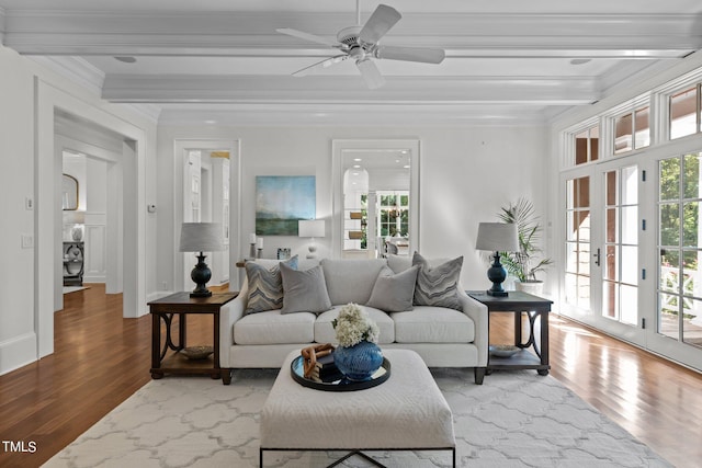 living room featuring hardwood / wood-style floors, ceiling fan, beamed ceiling, crown molding, and french doors