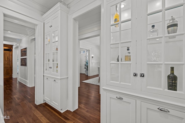 hall with ornamental molding and dark hardwood / wood-style floors