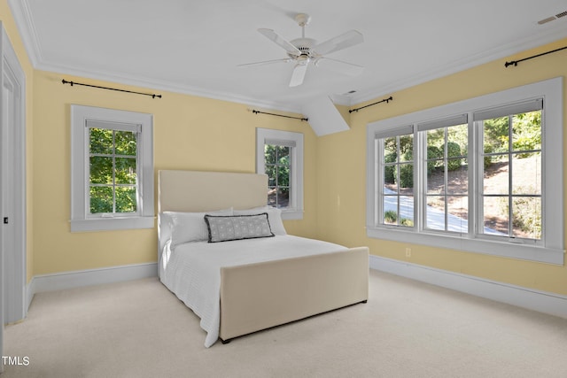 carpeted bedroom with multiple windows, ceiling fan, and crown molding