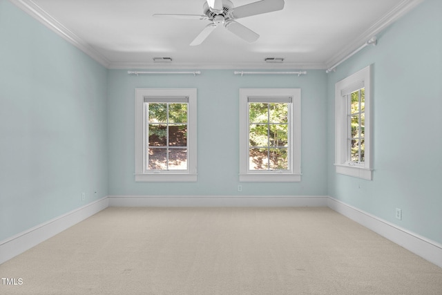 carpeted empty room with crown molding and ceiling fan