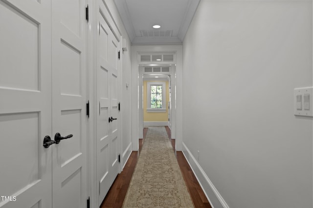 hallway with crown molding and dark hardwood / wood-style floors