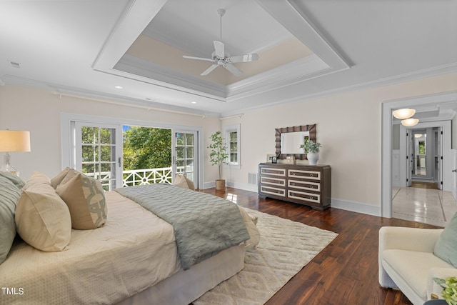 bedroom featuring access to exterior, dark hardwood / wood-style floors, a tray ceiling, ornamental molding, and ceiling fan