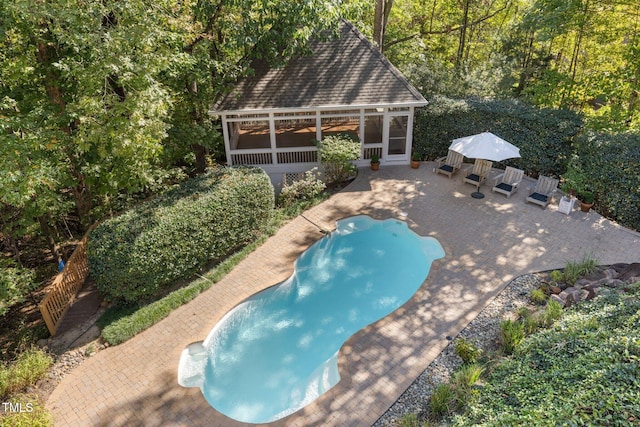 view of pool with a patio and a sunroom