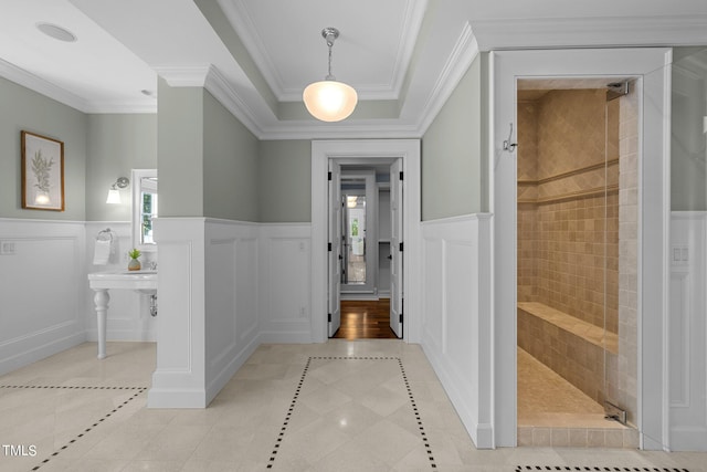 corridor featuring crown molding and light tile patterned floors