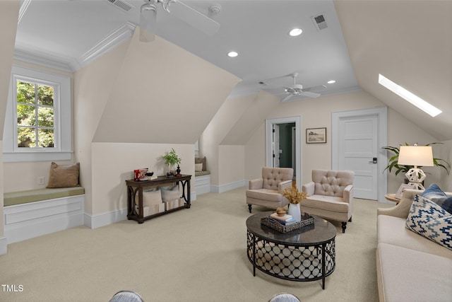 living room featuring lofted ceiling with skylight, light carpet, and ceiling fan