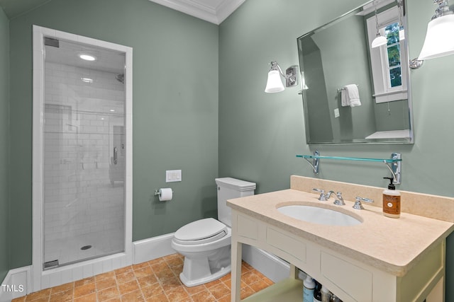 bathroom featuring vanity, toilet, ornamental molding, and a shower with shower door