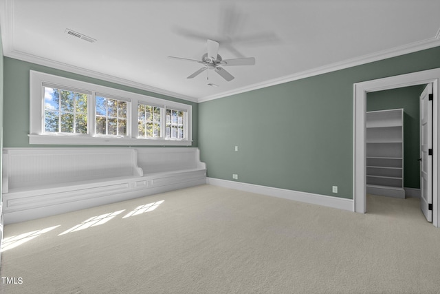 carpeted spare room featuring ornamental molding and ceiling fan