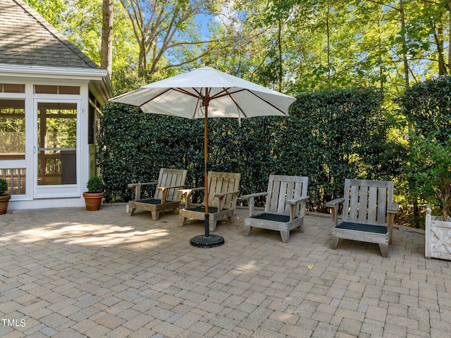 view of patio featuring a sunroom