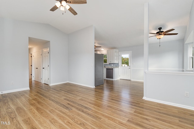 unfurnished living room featuring light hardwood / wood-style floors, ceiling fan, and vaulted ceiling