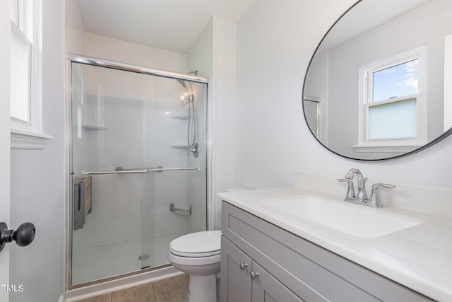 bathroom with a shower with door, a textured ceiling, toilet, tile patterned floors, and vanity