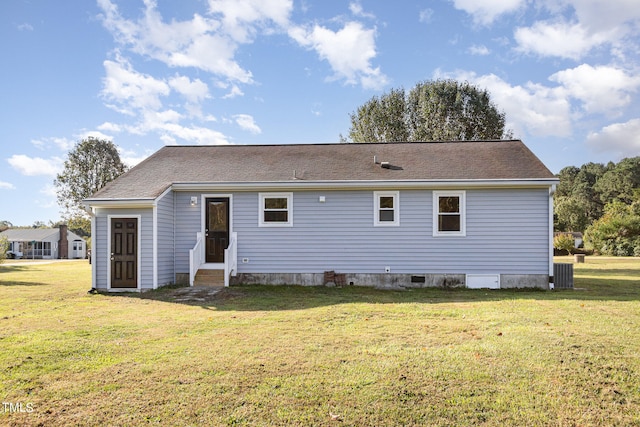 rear view of house featuring central AC and a yard