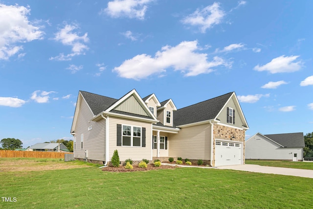 craftsman-style house featuring a garage, a front lawn, and central AC unit