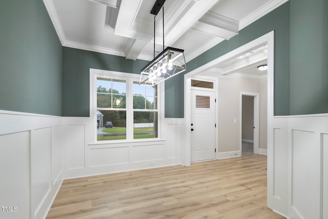 unfurnished dining area featuring light hardwood / wood-style floors, crown molding, and beamed ceiling