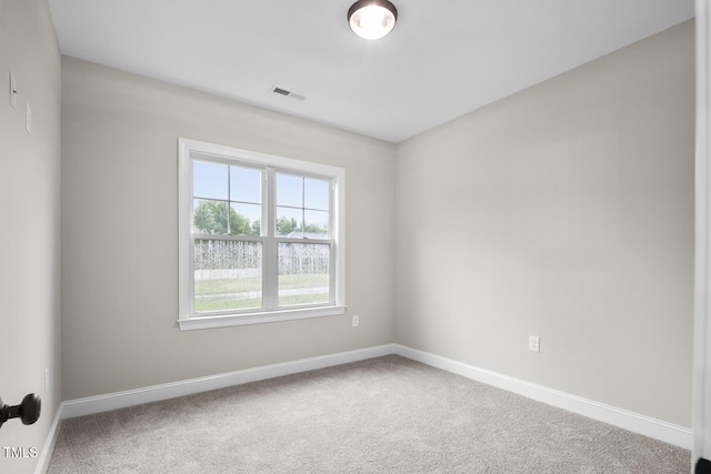 unfurnished room with carpet flooring, baseboards, and visible vents