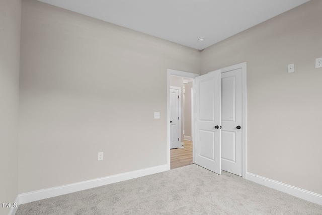 unfurnished bedroom with light colored carpet