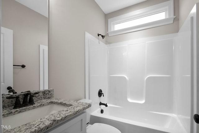 full bathroom featuring toilet, bathtub / shower combination, vanity, and vaulted ceiling