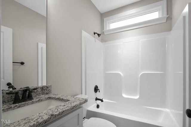 full bath featuring  shower combination, toilet, and vanity