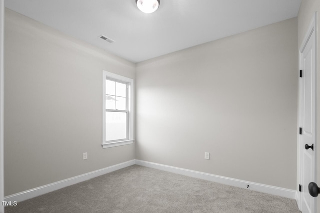 spare room featuring carpet, baseboards, and visible vents