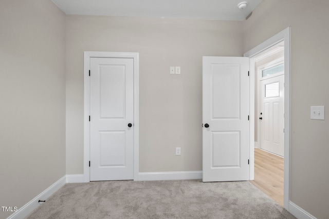 unfurnished bedroom featuring light colored carpet